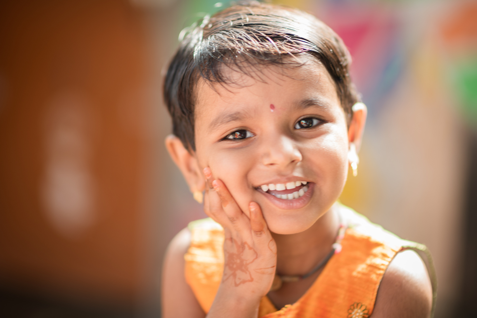 Smiling Child with Traditional Henna Tattoo in Hand 